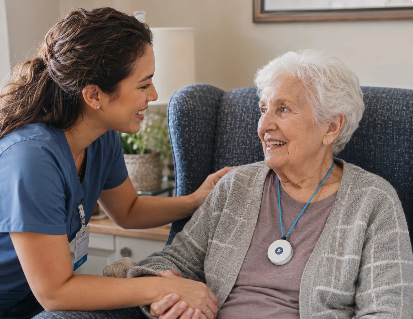 A caregiver smiling with a resident who wears the JXN pendant